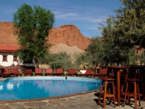 Guests relaxing by the pool at a desert lodge in Namibia