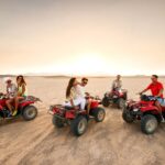 A quad biker racing across the golden dunes of Namibia.