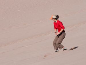 Dune riders enjoying the thrill of sandboarding in the Namib Desert.