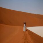 Woman posing for a picture at the Sossusvlei sand dunes